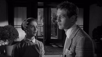 Movie still from “Somebody Up There Likes Me” (1956), directed by Robert Wise – A man and a woman standing next to each other; Close Up shot, Low angle