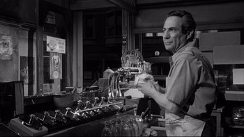 Movie still from “Somebody Up There Likes Me” (1956), directed by Robert Wise – An older man working in an industrial setting; Medium shot, Low angle