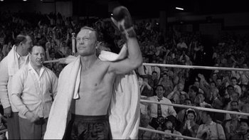 Movie still from “Somebody Up There Likes Me” (1956), directed by Robert Wise – A man in a boxing ring getting ready for a fight; Medium shot, Low angle