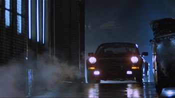 Movie still from “Someone to Watch Over Me” (1987), directed by Ridley Scott – A car that is parked on the side of the street; Wide shot, Low angle