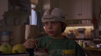 Movie still from “Someone to Watch Over Me” (1987), directed by Ridley Scott – A young boy wearing a baseball cap while holding a spoon in his hand; Close Up shot, Low angle