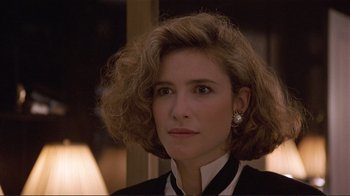 Movie still from “Someone to Watch Over Me” (1987), directed by Ridley Scott – A person wearing a suit and tie; Close Up shot, Over the shoulder angle