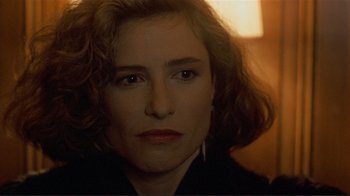 Movie still from “Someone to Watch Over Me” (1987), directed by Ridley Scott – A woman's face in the dark; Close Up shot, Over the shoulder angle