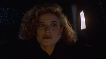 Movie still from “Someone to Watch Over Me” (1987), directed by Ridley Scott – A person wearing a black shirt; Close Up shot, Low angle