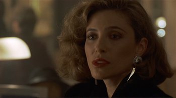 Movie still from “Someone to Watch Over Me” (1987), directed by Ridley Scott – A person wearing a suit and tie; Close Up shot, Over the shoulder angle