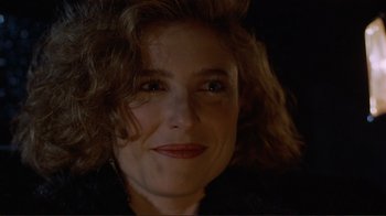 Movie still from “Someone to Watch Over Me” (1987), directed by Ridley Scott – A woman's face in the dark; Close Up shot, Over the shoulder angle