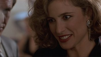 Movie still from “Someone to Watch Over Me” (1987), directed by Ridley Scott – A woman's face with red lipstick; Close Up shot, Over the shoulder angle