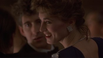 Movie still from “Someone to Watch Over Me” (1987), directed by Ridley Scott – A man and a woman are smiling for the camera; Close Up shot, Over the shoulder angle
