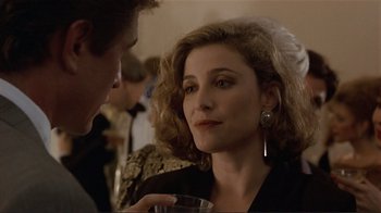 Movie still from “Someone to Watch Over Me” (1987), directed by Ridley Scott – A woman is talking to a man at a party; Close Up shot, Over the shoulder angle