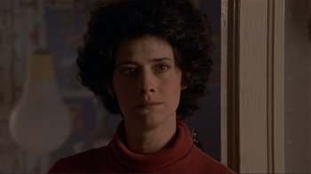 Movie still from “Someone to Watch Over Me” (1987), directed by Ridley Scott – A person wearing a red shirt; Close Up shot, Low angle