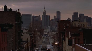 Movie still from “Someone to Watch Over Me” (1987), directed by Ridley Scott – A view of a city skyline at dusk or dawn; Extreme Wide shot, High angle