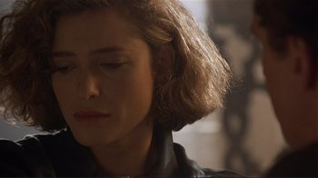 Movie still from “Someone to Watch Over Me” (1987), directed by Ridley Scott – A person wearing a black jacket; Close Up shot, Over the shoulder angle