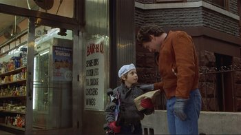 Movie still from “Someone to Watch Over Me” (1987), directed by Ridley Scott – A man and a woman standing on the sidewalk; Medium shot, Over the shoulder angle