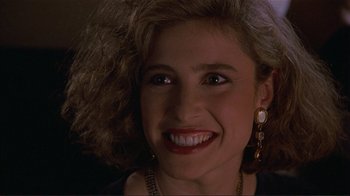 Movie still from “Someone to Watch Over Me” (1987), directed by Ridley Scott – A person with a smile on their face; Close Up shot, High angle