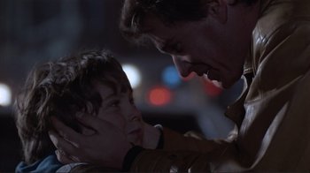 Movie still from “Someone to Watch Over Me” (1987), directed by Ridley Scott – A man and a boy looking at each other; Close Up shot, Over the shoulder angle
