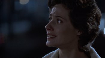 Movie still from “Someone to Watch Over Me” (1987), directed by Ridley Scott – A person looking up at something; Close Up shot, Over the shoulder angle