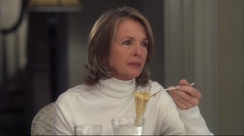 Movie still from “Something's Gotta Give” (2003), directed by Nancy Meyers – A woman in a white sweater eating noodles; Close Up shot, Over the shoulder angle