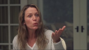 Movie still from “Something's Gotta Give” (2003), directed by Nancy Meyers – A woman with long brown hair is holding her hand out to the camera; Close Up shot, Over the shoulder angle