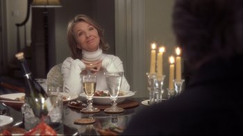 Movie still from “Something's Gotta Give” (2003), directed by Nancy Meyers – A woman sitting at a table with a plate of food; Medium shot, Over the shoulder angle