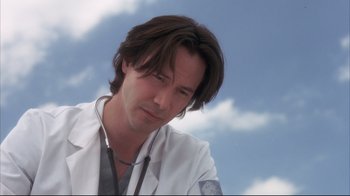 Movie still from “Something's Gotta Give” (2003), directed by Nancy Meyers – A man in a white lab coat and stethoscope looks to his left; Close Up shot, Low angle