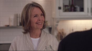 Movie still from “Something's Gotta Give” (2003), directed by Nancy Meyers – A woman with short blonde hair smiles at the camera; Close Up shot, Over the shoulder angle