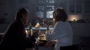 Movie still from “Something's Gotta Give” (2003), directed by Nancy Meyers – A man and a woman sitting at a dinner table; Medium shot, Over the shoulder angle