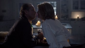Movie still from “Something's Gotta Give” (2003), directed by Nancy Meyers – A man and a woman kissing at a table; Medium shot, Over the shoulder angle