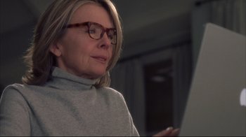 Movie still from “Something's Gotta Give” (2003), directed by Nancy Meyers – A person wearing glasses and a sweater; Close Up shot, Over the shoulder angle