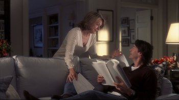 Movie still from “Something's Gotta Give” (2003), directed by Nancy Meyers – Two people sitting on a couch with papers in their hands; Medium shot, Over the shoulder angle