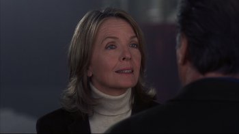 Movie still from “Something's Gotta Give” (2003), directed by Nancy Meyers – An older woman wearing a black jacket and a white sweater; Close Up shot, Over the shoulder angle