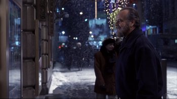 Movie still from “Something's Gotta Give” (2003), directed by Nancy Meyers – A man standing in front of a building in the snow; Medium shot, Over the shoulder angle