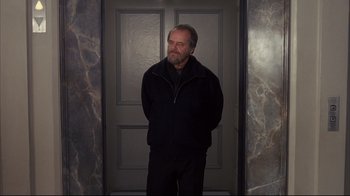 Movie still from “Something's Gotta Give” (2003), directed by Nancy Meyers – A man standing in front of a door wearing a black jacket; Medium shot, Low angle