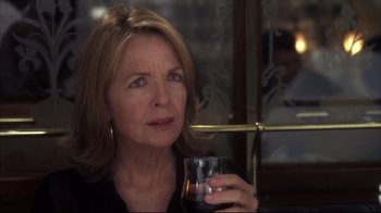 Movie still from “Something's Gotta Give” (2003), directed by Nancy Meyers – A person holding a glass of wine; Close Up shot, Over the shoulder angle