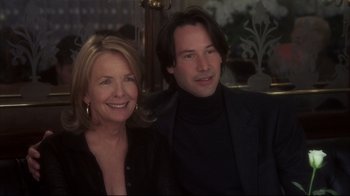 Movie still from “Something's Gotta Give” (2003), directed by Nancy Meyers – A man and a woman posing for a picture; Close Up shot, High angle
