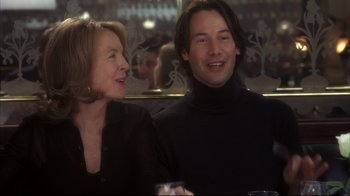 Movie still from “Something's Gotta Give” (2003), directed by Nancy Meyers – A man and a woman sitting next to each other at a table; Close Up shot, Over the shoulder angle