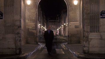 Movie still from “Something's Gotta Give” (2003), directed by Nancy Meyers – A man in a suit standing in the middle of an archway at night; Wide shot, Low angle