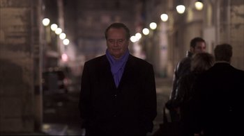 Movie still from “Something's Gotta Give” (2003), directed by Nancy Meyers – A man wearing a black jacket and a blue scarf; Medium shot, Low angle
