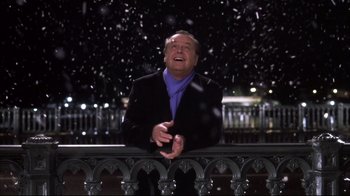 Movie still from “Something's Gotta Give” (2003), directed by Nancy Meyers – A man standing on top of a railing in the snow; Medium shot, Low angle
