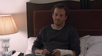Movie still from “Somewhere” (2010), directed by Sofia Coppola – A man sitting in a chair with a bandage on his arm; Medium shot, High angle