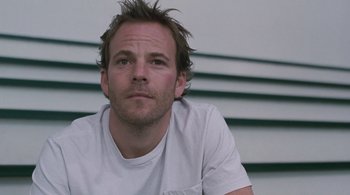Movie still from “Somewhere” (2010), directed by Sofia Coppola – A person wearing a white t - shirt; Close Up shot, Low angle