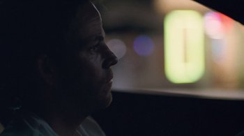 Movie still from “Somewhere” (2010), directed by Sofia Coppola – A person's face in the dark; Close Up shot, Over the shoulder angle