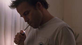 Movie still from “Somewhere” (2010), directed by Sofia Coppola – A man is smoking a cigarette in a room; Close Up shot, Low angle