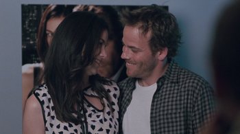 Movie still from “Somewhere” (2010), directed by Sofia Coppola – A man and a woman smiling at each other; Close Up shot, Over the shoulder angle