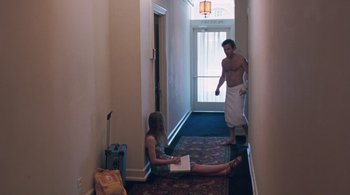 Movie still from “Somewhere” (2010), directed by Sofia Coppola – A man and a woman in the hallway of a hotel room; Wide shot, Over the shoulder angle