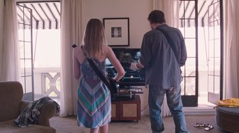 Movie still from “Somewhere” (2010), directed by Sofia Coppola – A man and a woman playing a video game together; Medium shot, Over the shoulder angle