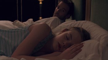 Movie still from “Somewhere” (2010), directed by Sofia Coppola – A man and a woman laying in a bed together; Medium shot, Over the shoulder angle
