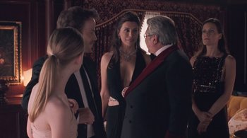 Movie still from “Somewhere” (2010), directed by Sofia Coppola – A group of people standing next to each other in a room; Medium shot, Over the shoulder angle