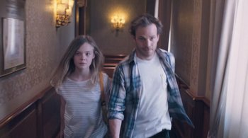 Movie still from “Somewhere” (2010), directed by Sofia Coppola – A man and a girl are walking down the stairs; Medium shot, High angle