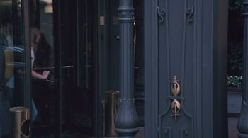 Movie still from “Somewhere” (2010), directed by Sofia Coppola – A street light on the side of a building; Medium shot, High angle
