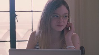 Movie still from “Somewhere” (2010), directed by Sofia Coppola – A girl with glasses talking on a cell phone; Close Up shot, Over the shoulder angle